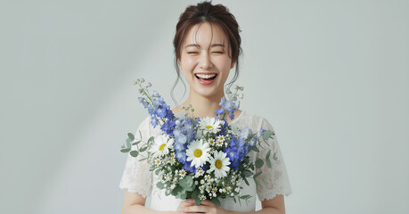 白いレースドレスを着て花束を持つ美しい女性のポートレート	