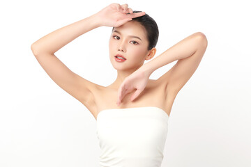 Naklejka premium Beautiful Young Asian woman Raises her hands to Showcase clean and hygienic underarms Against a white background, Smooth armpit cleanliness and protection concept