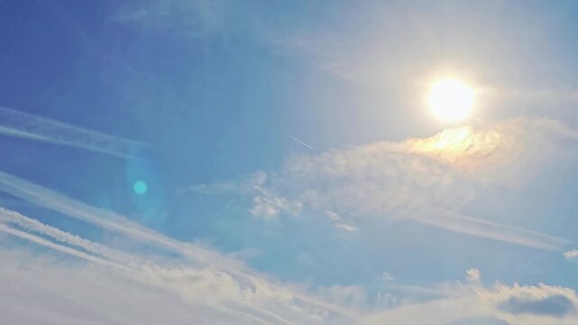 Commercial Jet Airplane Cruising at High Altitude in a Big Blue Sky With Clouds Making Contrails and Patterns in the Atmosphere, Airways, Air Travel, Sun Flair, No Audio, 19:6, Still Shot, 60fps - 3