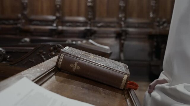 Monk Hands Opening Prayer Book for Quiet Meditation During Religious Ritual