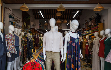 Elegant mannequins displaying formal fashion in boutique doorway