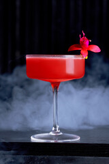 Red Craft Cocktail with Dried Orange and Fuchsia Flower