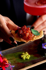 Close-up of Crispy Shrimp Tempura Sushi Roll with Creamy Sauce and Green Onions.