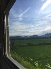 Obraz premium natural views of hills and expanses of rice fields seen from the train window