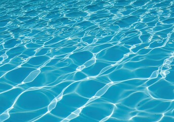 Bright sunlit ripples dance across the vibrant blue water surface, creating a refreshing and dynamic texture
