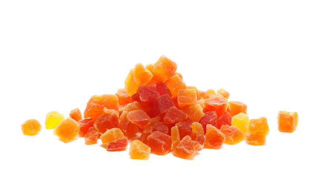 Heap dried papaya cubes with sugar, candied fruit isolated on white background, side view