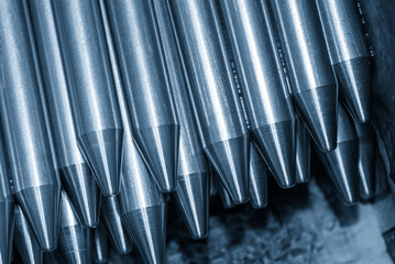 Pile of Metal Shaft Parts with Conical Ends in Light Blue Tone