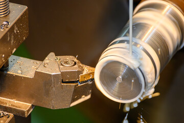 Close Up of Lathe Machine Finishing Metal Shaft with Liquid Coolant