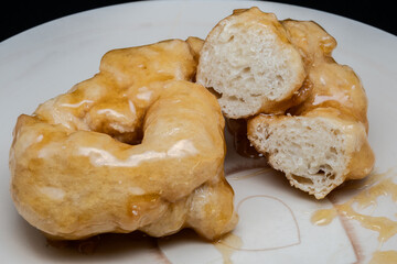 Fototapeta premium Campanian Christmas zeppole with honey are a typical treat from Campania during the holidays. They're made from a fried, leavened dough, then generously coated in warm honey.