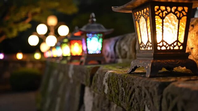 Ornate lanterns illuminate a stone wall their glowing light creating a vibrant path Focus is on a bronze lantern with intricate designs foreground with colorful lights fading behind