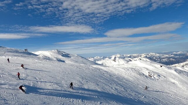 La Pierre Saint Martin, France - January 13, 2024. A snow-covered mountain landscape, filmed from a considerable height, from a chairlift. A snowy slope and white clearings are visible. 