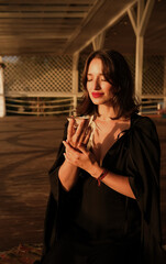 Evening Serenity: Woman In Black Dress With Cup