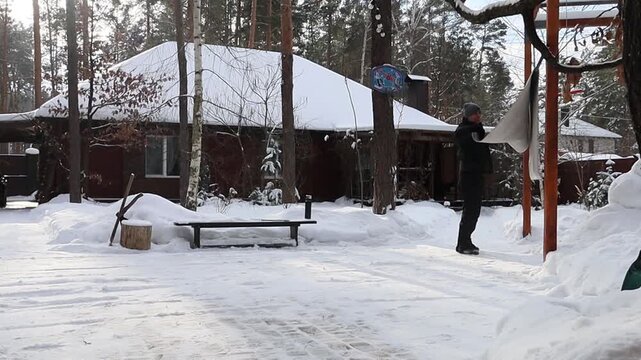 a man beats out and cleans a carpet
