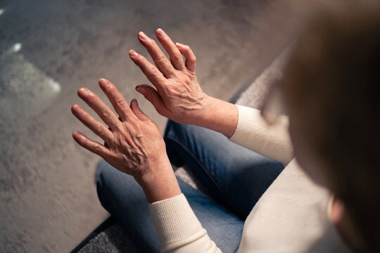 Senior woman showing hands with arthritis pain