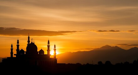 Fototapeta premium Sunset over a mosque with mountains in the background creating a serene landscape