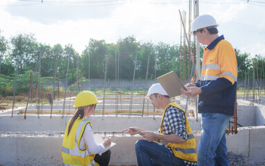 Male and female engineers who are Asian professionals in the construction industry focus on village design and architecture to create sustainable houses for people to rent and sell.