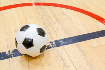 Football on an indoor soccer pitch ready for the match to kick off