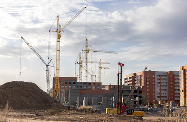 a construction site with high-rise cranes for the construction of multi-story buildings
