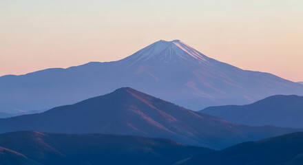 Distant view of a snowy mountain peak with rolling hills, creating depth and a serene atmosphere, representing natural grandeur and exploration