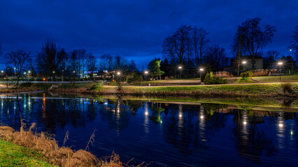 Fototapeta premium gorgeously decorated city in a Christmas mood, various lights and decorations, decorated facades of houses and fir trees, night landscape