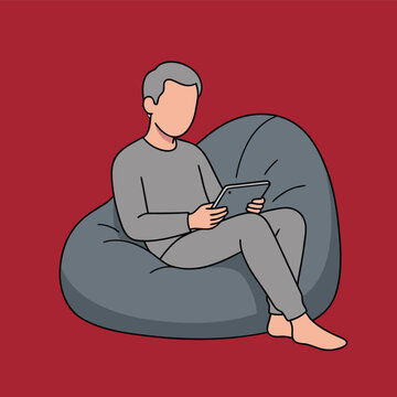 Man relaxing on a bean bag chair using a tablet.