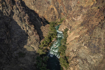 A stormy stream of a mountain river flows inside the Black canyon located in Kazakhstan