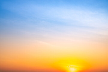 Obraz premium Sunset or sunrise sky with a vibrant gradient of orange, gold, and soft blue. Clear atmosphere with wispy clouds. Peaceful, natural light background. hope, freedom, new day and inspirational Concepts