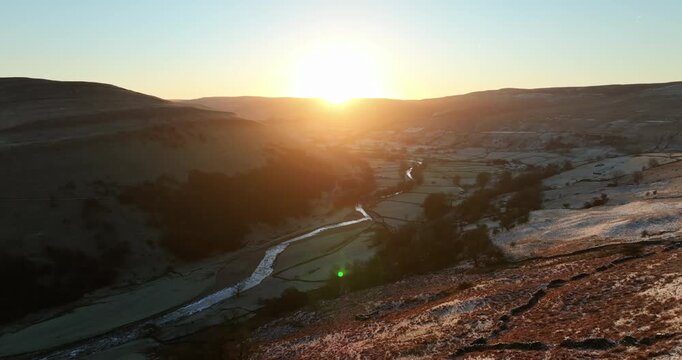 Aerial shot of a sunrise over frozen Swaledale