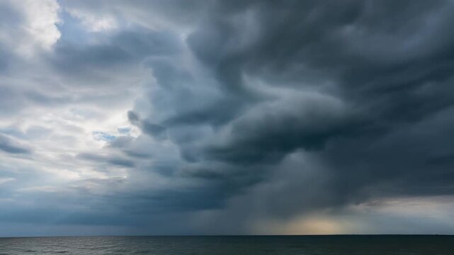 A timelapse of dark storm clouds gathering over the ocean's surface from a low viewpoint
