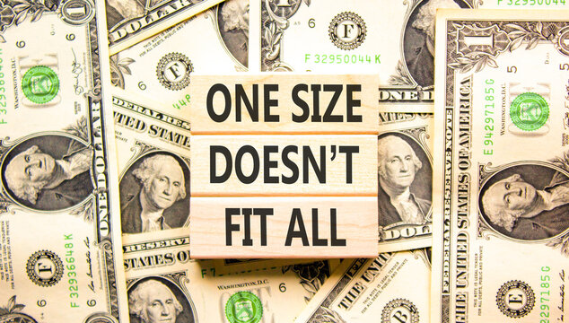 One size does not fit all symbol. Concept words One size does not fit all on beautiful wooden blocks. Beautiful dollar bills background. Business one size does not fit all concept. Copy space.