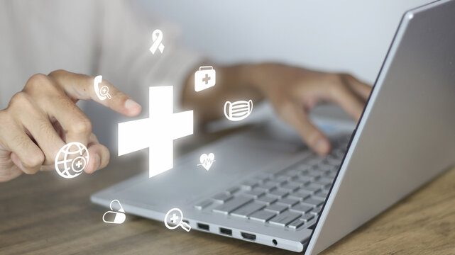 Telemedicine developer creating digital healthcare solutions by integrating virtual medical icons on a laptop interface to illustrate remote patient care, health monitoring, and accessible medicine