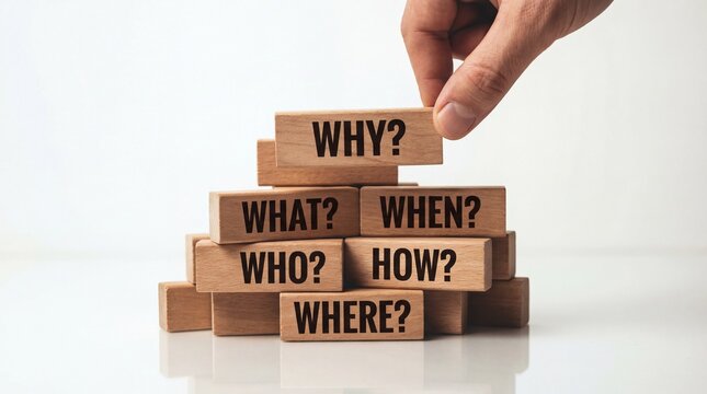 Hand placing wooden block with why question on top of pyramid made of blocks with what when who how and where questions
