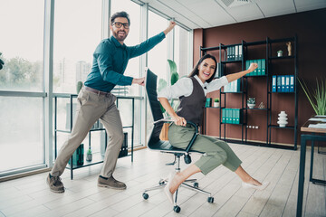 Business colleagues celebrate in a modern loft office as they work and have fun during a dynamic...