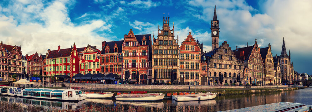 Ghent city historical center, tourists boats and colorful buildings on Leie river bank, Belgium