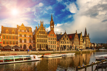 Fototapeta premium Ghent city historical center, tourists boats and colorful buildings on Leie river bank, Belgium
