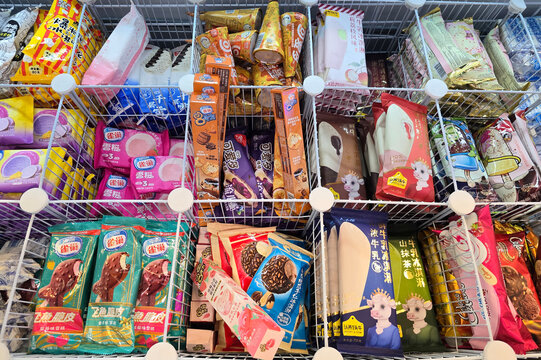 Penang, Malaysia: Nov 02, 2025: A variety of colorful imported snack packaging including Peko Pop lollipops, Peppa Pig treats, blueberry marshmallows and herbal candy displayed on store shelves.