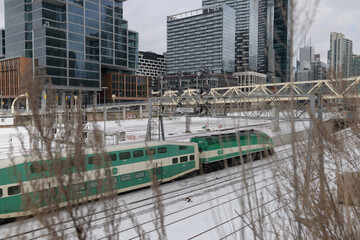 Naklejka premium Go Train entering the Union Station Rail Corridor viewed from Iceboat Terrace, Toronto