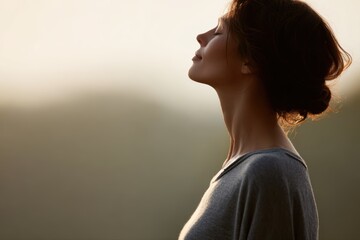 Woman practicing yoga breathing outdoors, calm spiritual wellness and mental balance in nature, soft morning light