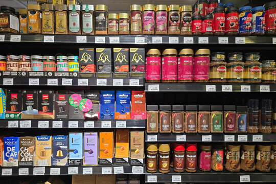 Penang, Malaysia: Nov 06, 2025: A well-stocked grocery aisle featuring a wide variety of coffee products including Nescafe Gold, L'OR espresso capsules, Lavazza, and Davidoff instant coffee jars.