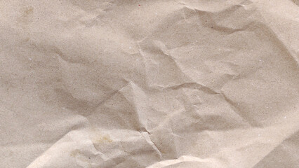 High quality textured background of old crumpled brown kraft paper with wrinkles and creases
