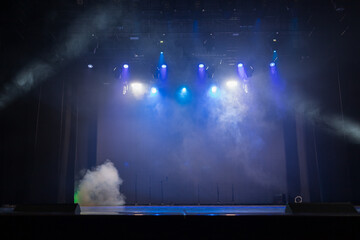 The stage of the theater illuminated by spotlights from the auditorium