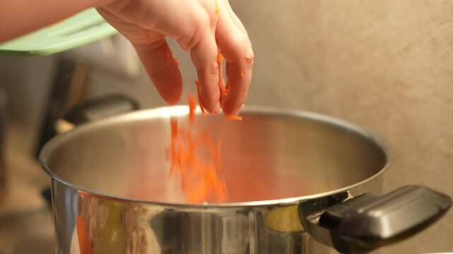 Carrots are poured into a saucepan with broth