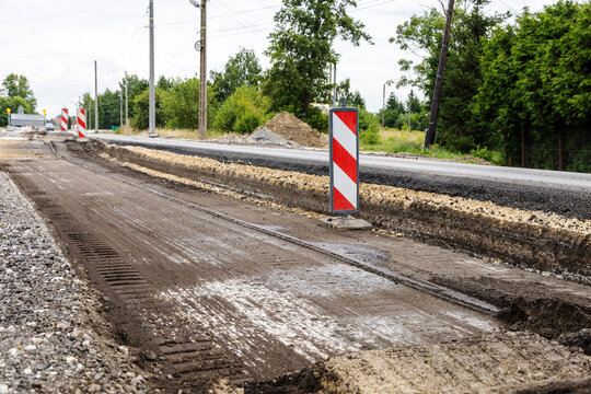 The layer of asphalt road with soil and rock. Un-focus image. Road reconstruction process.