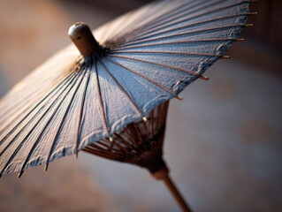 Obraz premium Thai paper umbrella craft with delicate wooden frame and traditional handmade design, showcasing cultural artistry and soft natural colors in outdoor sunlight