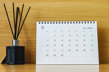 Office desk calendar showing September 2026 with copy space on wooden background, ideal for business planning, scheduling, and time management concepts.