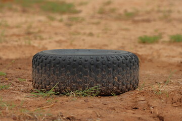 Obraz premium tire on the ground in the field, closeup of photo