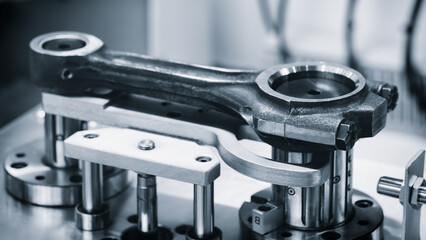 Engine repair, connecting rod on a test bench for quality control, auto service repair concept...