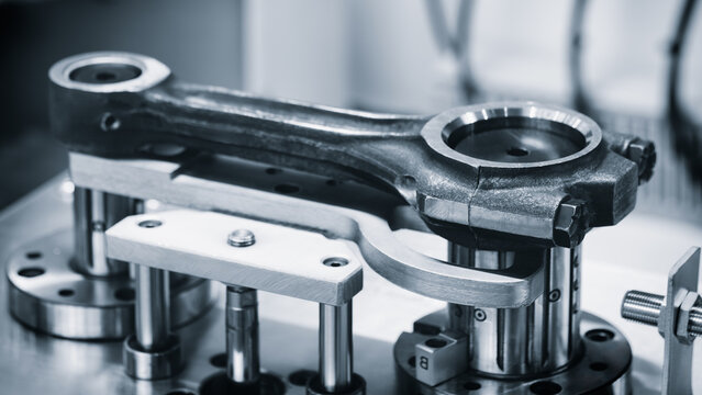 Engine repair, connecting rod on a test bench for quality control, auto service repair concept background