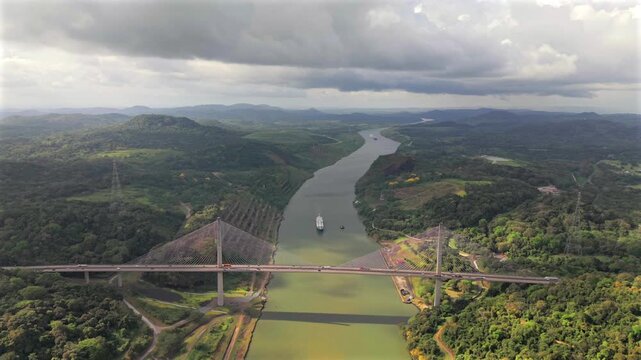 Cargo ship passing bridge in the Panama Canal