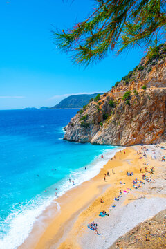 The famous "Kaputas Beach". Excellent nature and sea. People entering the sea and the beach. Beach umbrellas and sun beds. View of the beach from above. Kas region, Antalya, Turkey. 